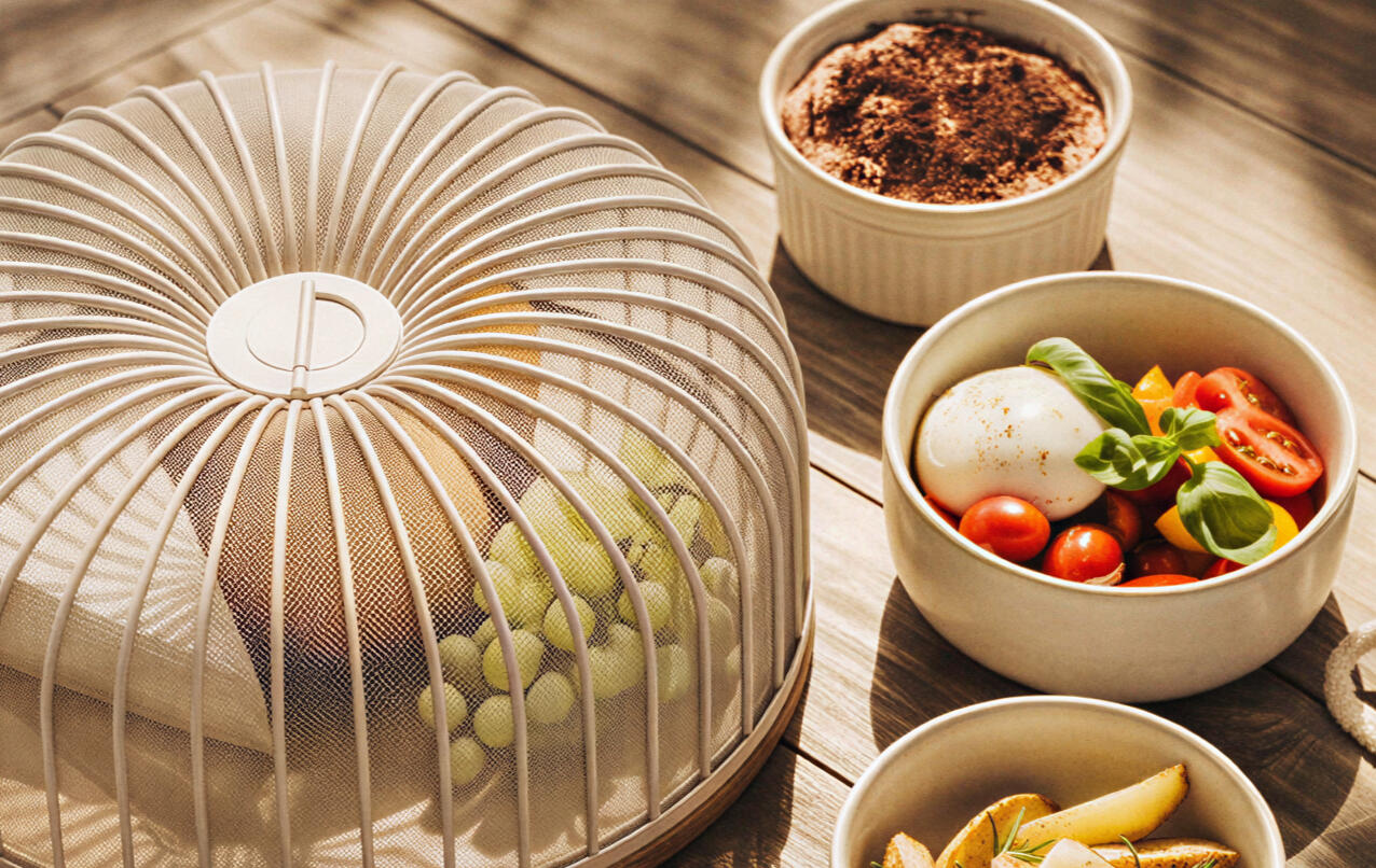 konfal basket covering fruit beside serving bowls on a table